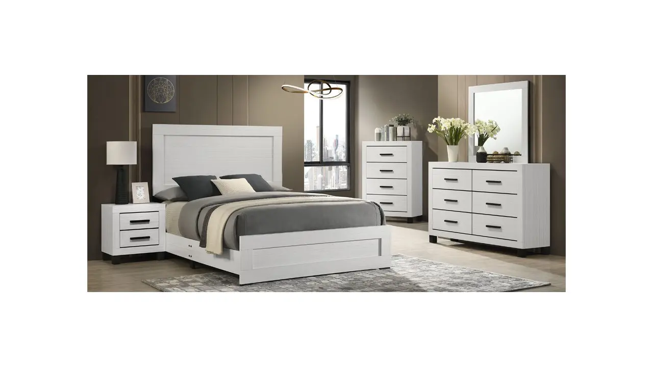 A white bed with grey sheets and pillows