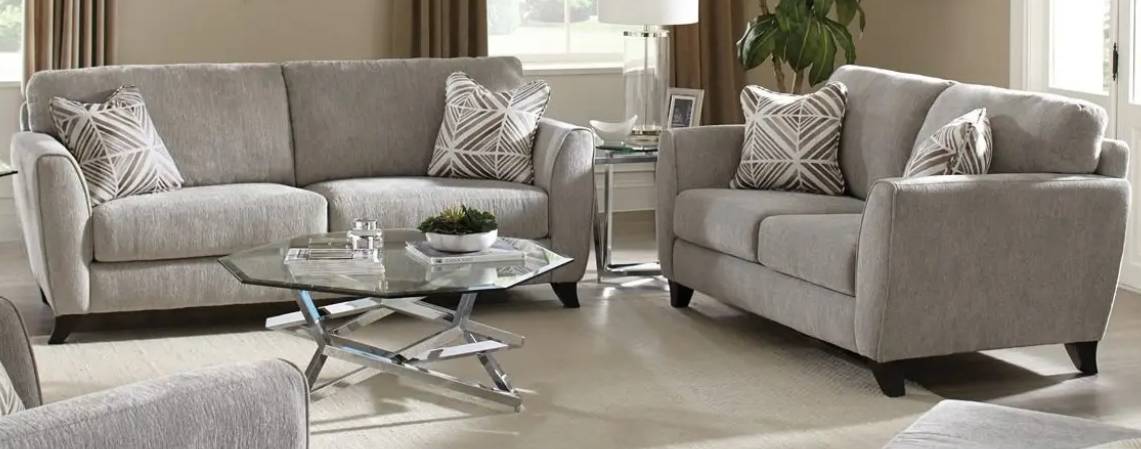 Gray sofas with geometric pillows in living room.