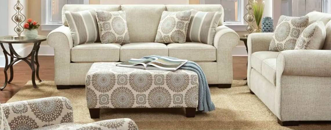 Living room with beige sofa and ottoman.