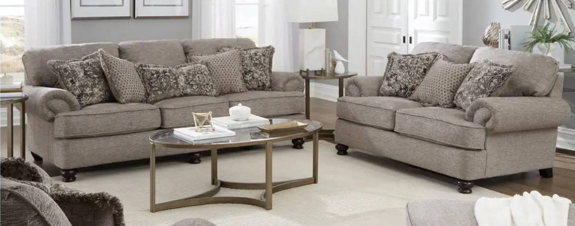 Gray sofas with patterned pillows in living room.