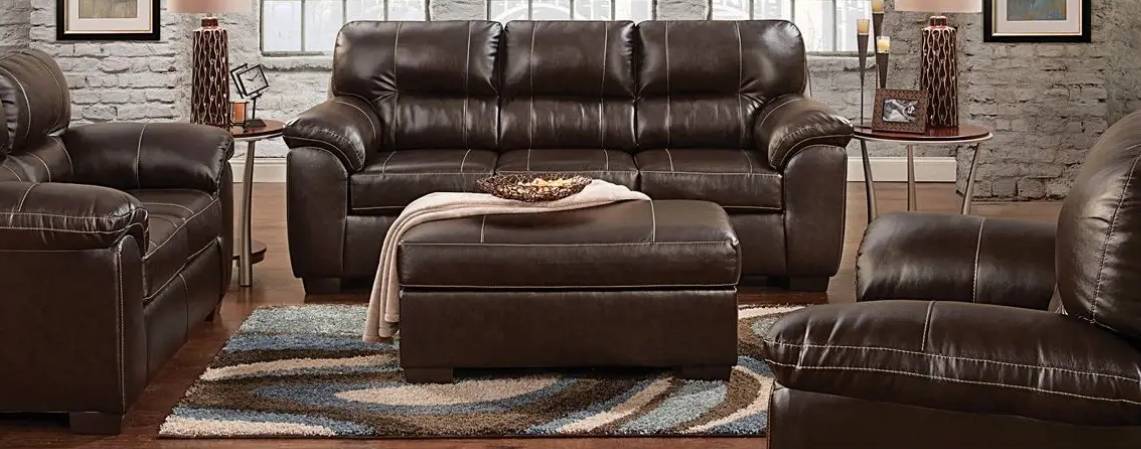 Brown leather sofa set in living room.