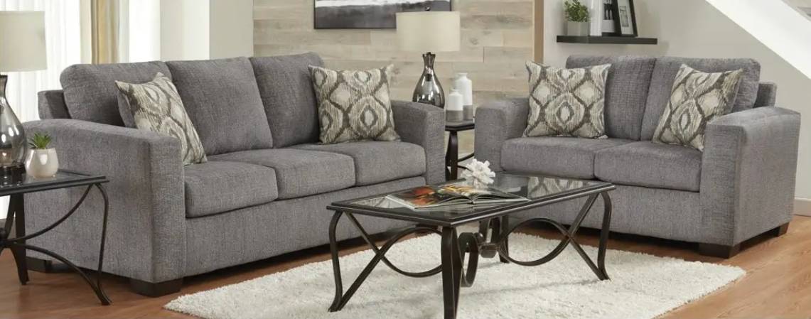 Gray sofas with patterned pillows in living room.
