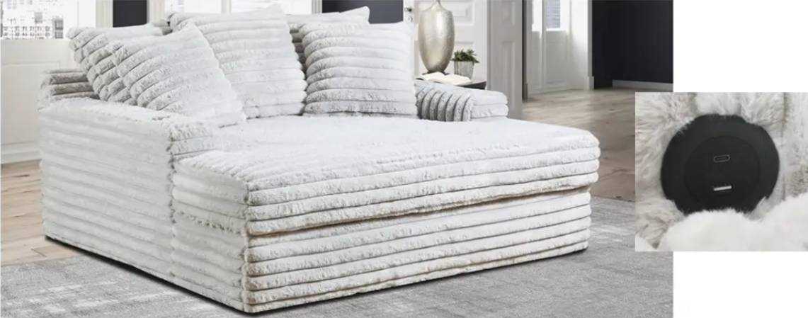 White plush sofa with striped cushions.