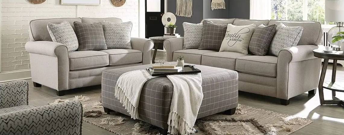 Gray living room furniture with patterned cushions.