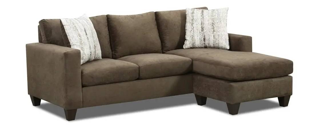 Brown sectional sofa with two decorative pillows.