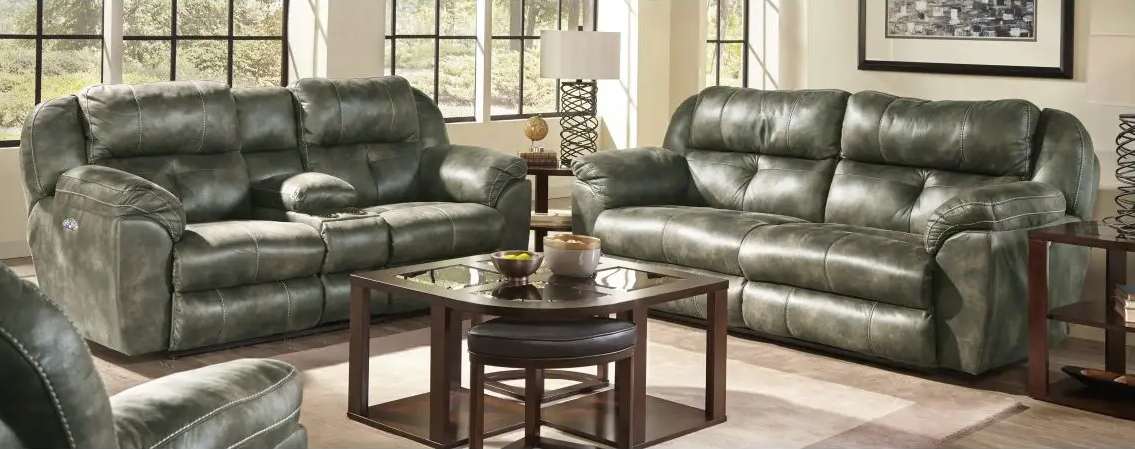 Green leather sofas in a cozy living room.