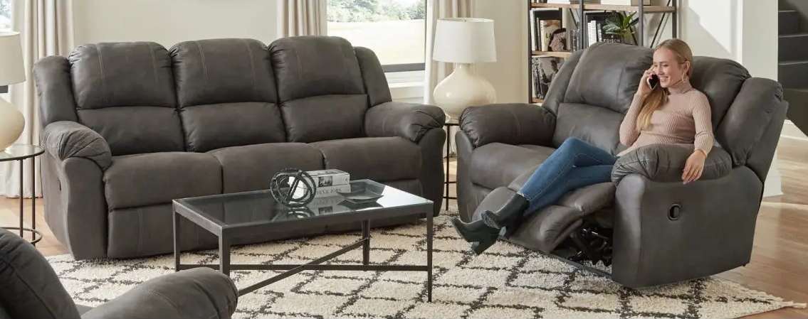 Woman relaxing on recliner, talking on phone.
