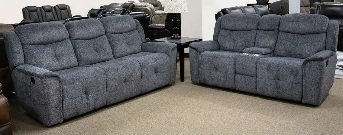 Gray reclining sofas in showroom setting.