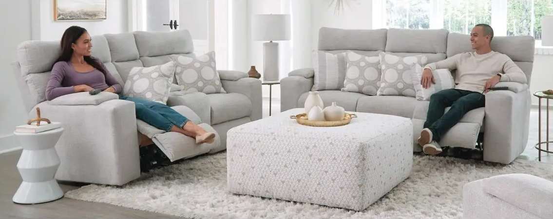 People relaxing on modern reclining sofas.