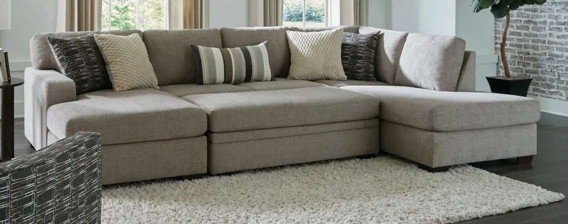 Gray sectional sofa with decorative pillows.