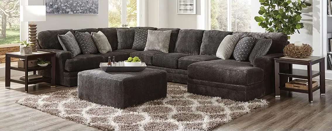 Spacious living room with dark sectional sofa.