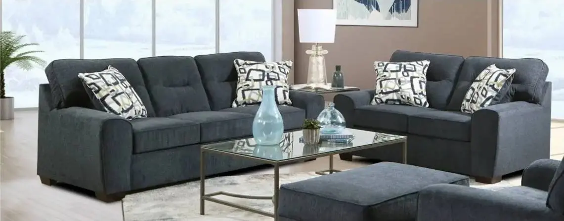 A modern living room features two dark gray sofas